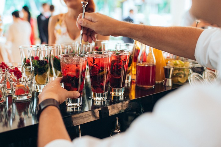 a bartender making cocktails at the bar