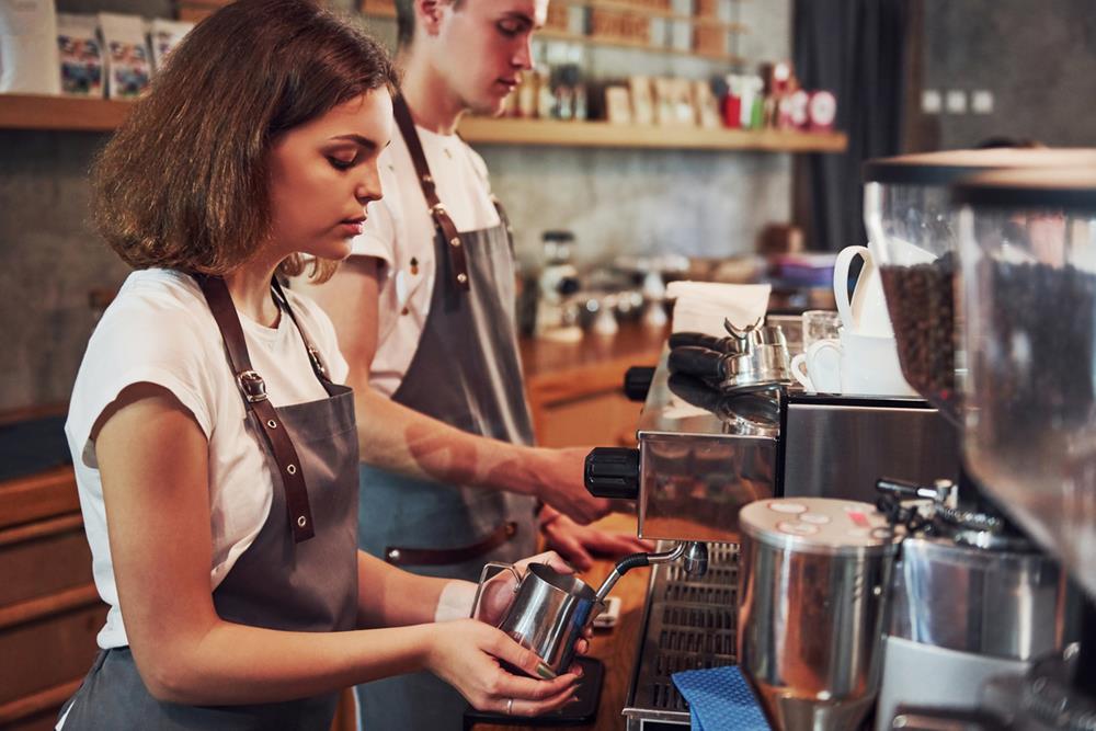 2 servers working in a coffee bar