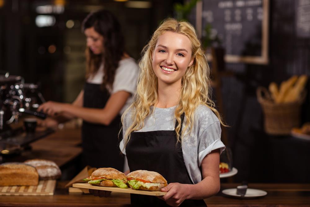 Waitress holding a tray with sandwiches