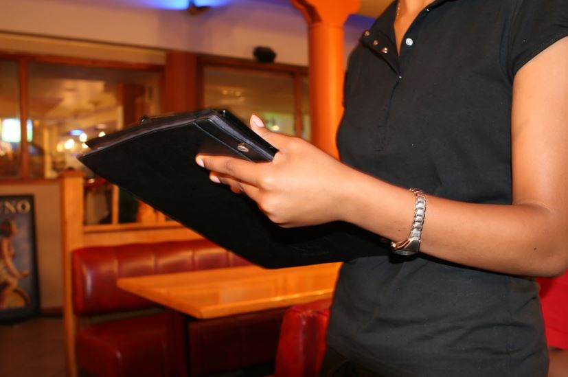 a server taking an order on their tablet