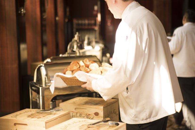 a server with bread for appetizer
