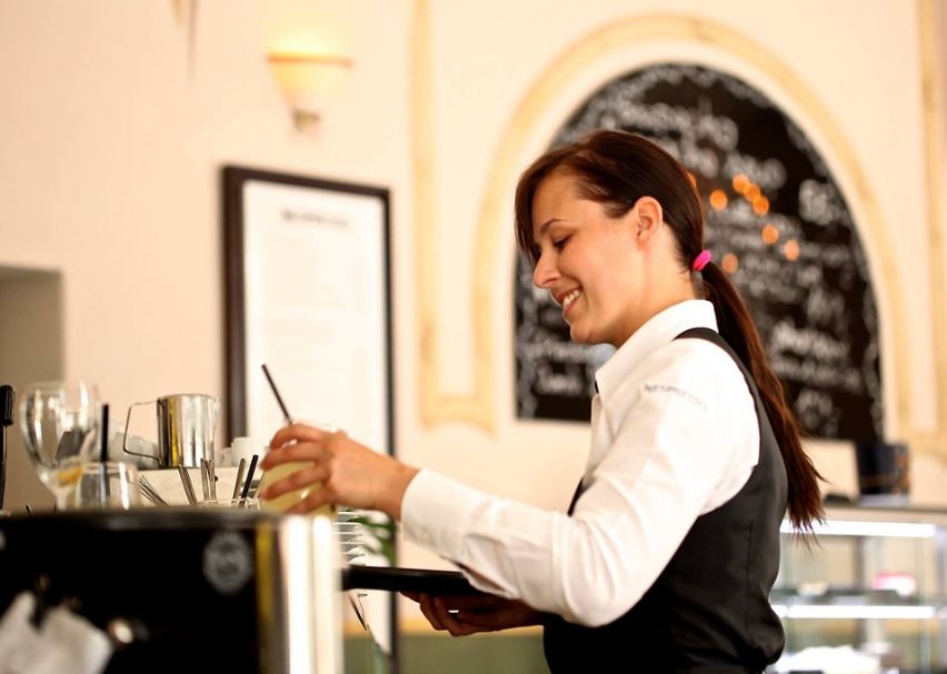 A waiter about to serve some drinks