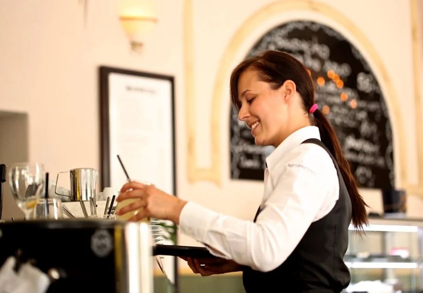 A waitress delivering food and drinks