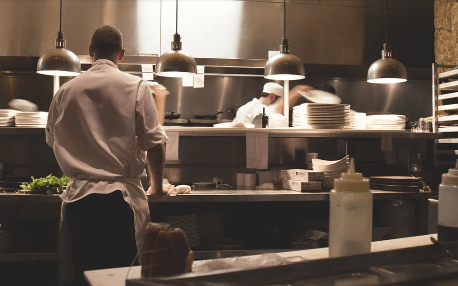 Image of two servers working together in a kitchen.